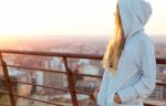 Beautiful Blonde Stands On The Edge Of The Roof Stock Photo