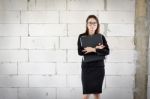 Businesswoman Standing Holding A File  In A Brick Building Stock Photo