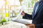 Business Man Working At Office With Laptop, Tablet And Graph Dat Stock Photo