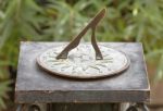 Ancient Roman Sundial In Garden Stock Photo