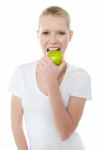 Young Lady Eating Green Apple Stock Photo