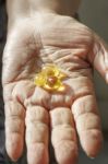 Elderly Hand With Supplement Stock Photo