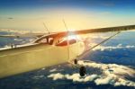 Propeller Plane Flying Over High Mountain For Traveling Theme Stock Photo