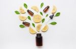 Medicine Bottle With Fresh Lemon Slices And Leaf On White Stock Photo