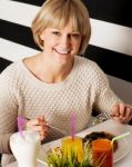 Beautiful Middle Aged Lady Enjoying Her Meal Stock Photo