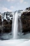 View Of Seljalandfoss Waterfall In Winter Stock Photo