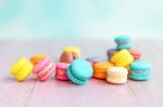 Colorful Macarons On A Pink Wooden Table Stock Photo