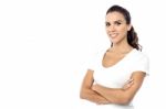 Smiling Female Posing With Arms Crossed Stock Photo