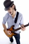 Guy Looking At Camera And Playing Guitar Stock Photo