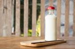 Bottle Of Milk On Wooden Table Stock Photo