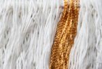 Texture Of Wool Fringe And White And Gold Threads Stock Photo