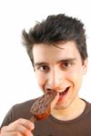 Portrait Of A Cute Young Man Eating An Ice-cream Stock Photo