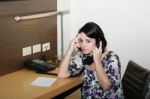 Stressed Businesswoman Holding Her Forehead While Speaking On Th Stock Photo