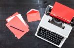 Typewriter And A Red Paper  On Wooden Background Retro Stock Photo