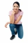 Crouched Woman Posing Casually Stock Photo