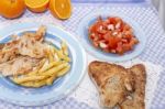 Turkey Steak With French Fries And Tomato Salad Stock Photo