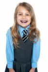 An Excited School Girl In Uniform Wearing Braces Stock Photo