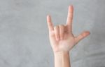 Hand Action Gesture On Grey Background Stock Photo