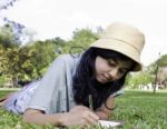 Young Asia Girl Writting A Book Stock Photo