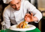 Professional Chef Preparing Baked Salmon Stock Photo