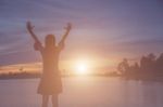 Silhouette Of Woman Praying Over Beautiful Sky Background Stock Photo