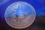 Blue Light On Bitcoin Currency Coin Extreme Close-up Stock Photo