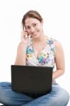 Lady Talking Over Phone With Laptop Stock Photo