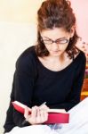 Woman Reading Book At Home Stock Photo