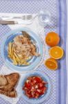 Turkey Steak With French Fries And Tomato Salad Stock Photo