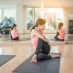 Asian Woman Doing Yoga Indoors Stock Photo