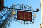 Colourful Hanging Sign In On A Building In Hallstatt Stock Photo