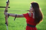 Girl Drawing Recurve Bow With Green Background Stock Photo