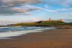 Sunset Over Dunstanburgh Castle Stock Photo