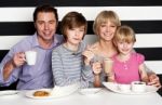 Family Enjoying Breakfast At A Restaurant Stock Photo