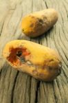 Moldy Papaya Fruit On Wood Background Stock Photo