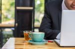 Business Man Using Portable Laptop Computer While Sitting In The Stock Photo