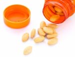 Closeup Of Orange Pills And Pill Bottle Stock Photo