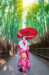 Bamboo Forest. Asian Woman Wearing Japanese Traditional Kimono At Bamboo Forest In Kyoto, Japan Stock Photo