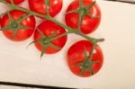 Fresh Cherry Tomatoes On A Cluster Stock Photo