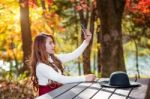 Beautiful Woman In Fall Forest Park Taking Selfie Self Photo With Smartphone Stock Photo