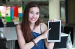 Portrait Of Thai Adult Beautiful Girl Using Her Tablet And Smile In University Stock Photo