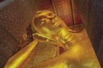 Reclining Buddha Gold Statue Face Stock Photo