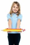 Cute Kid In Casuals Holding Colorful Pencils Stock Photo