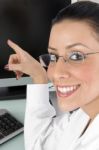 Smiling Doctor Pointing Desktop Stock Photo