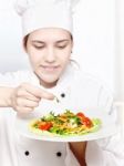 Young Chef Decorating Delicious Salad Stock Photo