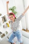 Beautiful Young Woman Listening To Music At Home Stock Photo