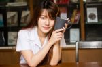 Portrait Of Thai Adult Student University Uniform Beautiful Drinking Coffee Stock Photo