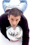 Man Lying With Disco Ball Stock Photo