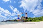 Happy Family Jumping On Beach In Thailand Stock Photo