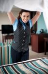 Lady Attendant Arranging Bed Sheet Stock Photo